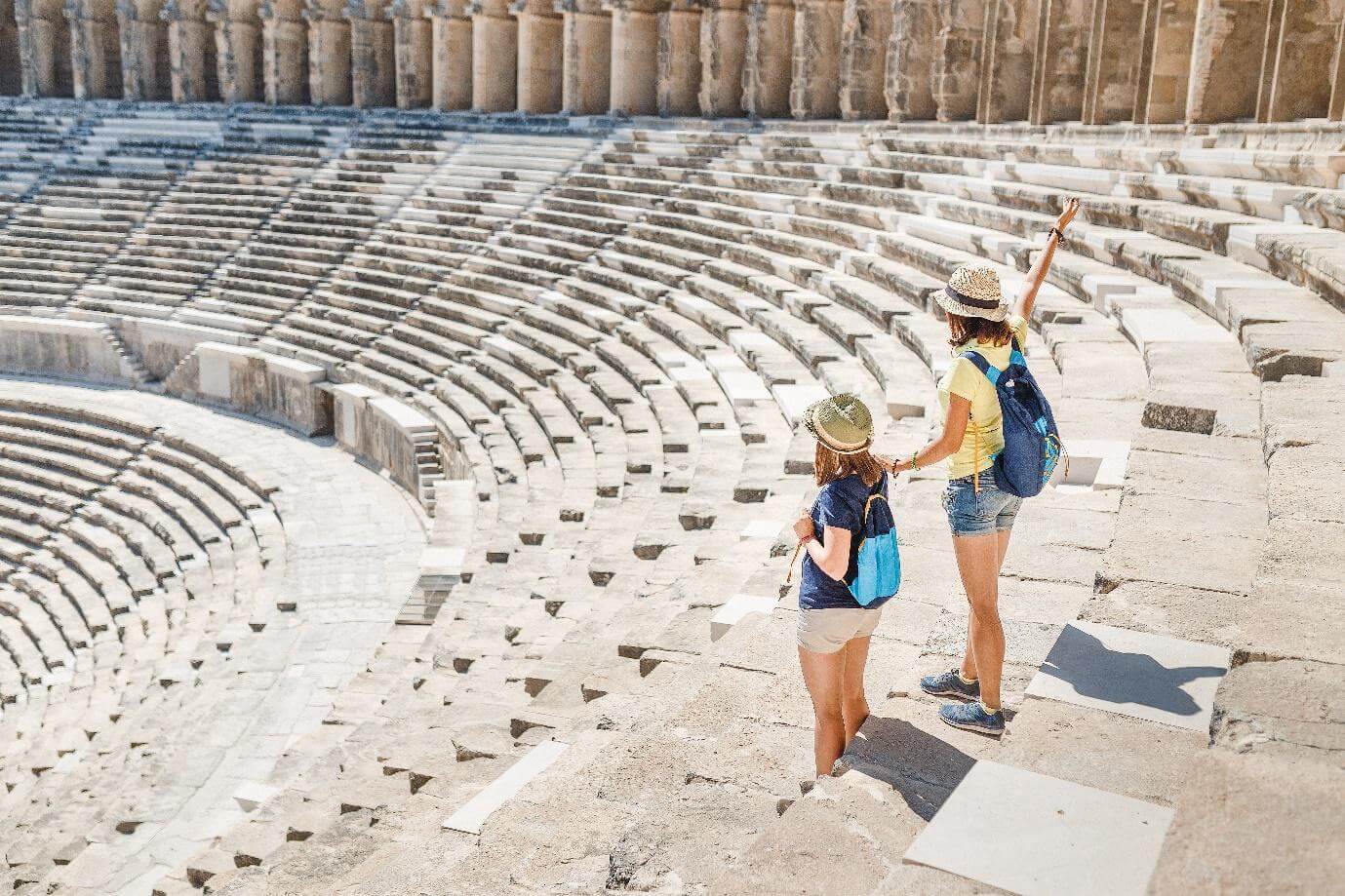 Two young girls student traveler in the ancient amphitheater. archaelolgy travel concept.Athens, Greece.